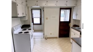 Kitchen with many cabinets and a white range oven