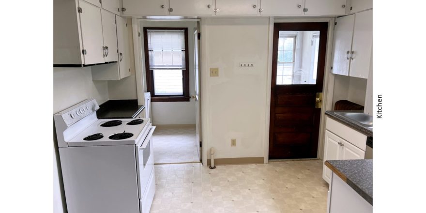 Kitchen with many cabinets and a white range oven