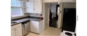Kitchen with many cabinets, white range oven, black fridge, and stainless steel dishwasher