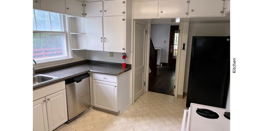 Kitchen with many cabinets, white range oven, black fridge, and stainless steel dishwasher