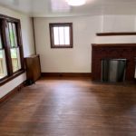 Unfurnished living room with large picture window and decorative fireplace