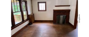 Unfurnished living room with large picture window and decorative fireplace