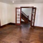 Unfurnished living room with hardwood floors and French Doors into the Entryway