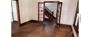 Unfurnished living room with hardwood floors and French Doors into the Entryway