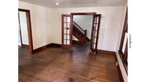 Unfurnished living room with hardwood floors and French Doors into the Entryway