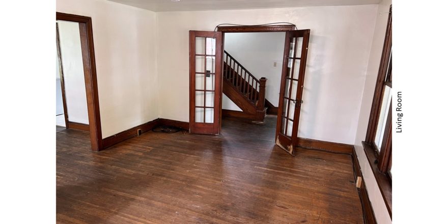 Unfurnished living room with hardwood floors and French Doors into the Entryway