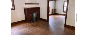 Unfurnished living room with hardwood floors and decorative fireplace