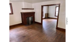 Unfurnished living room with hardwood floors and decorative fireplace