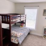 Bedroom with bunk bed and small bookcase