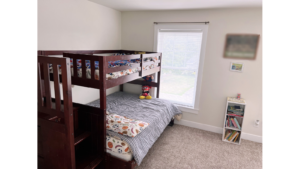 Bedroom with bunk bed and small bookcase