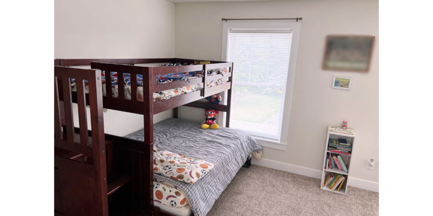 Bedroom with bunk bed and small bookcase