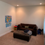 Family room with couch and ottoman