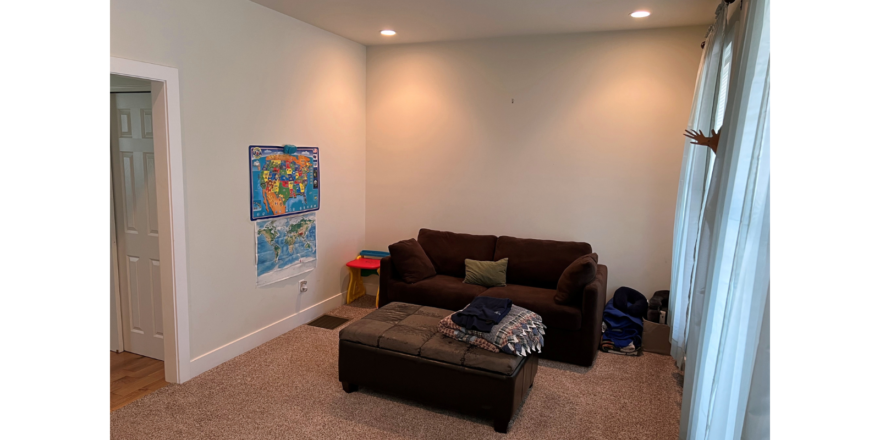 Family room with couch and ottoman