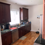 Kitchen with dark wood-tone cabinets and stainless steel appliances