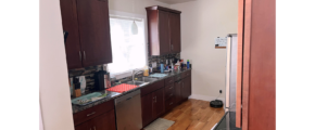 Kitchen with dark wood-tone cabinets and stainless steel appliances