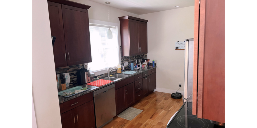 Kitchen with dark wood-tone cabinets and stainless steel appliances