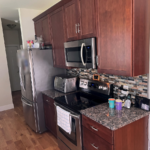 Kitchen with dark wood-tone cabinets and stainless steel appliances