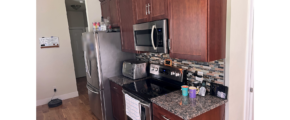 Kitchen with dark wood-tone cabinets and stainless steel appliances