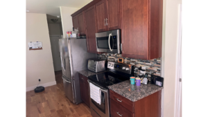 Kitchen with dark wood-tone cabinets and stainless steel appliances