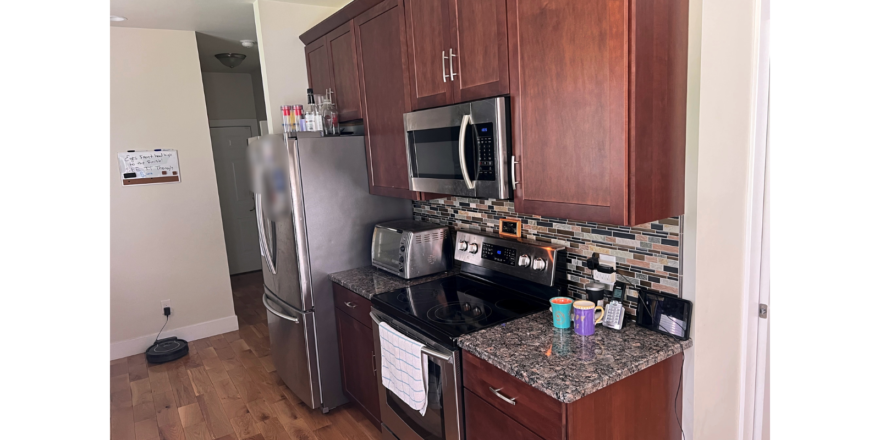 Kitchen with dark wood-tone cabinets and stainless steel appliances