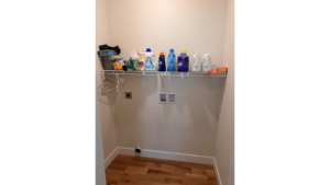 Laundry room with hookups and wire shelving