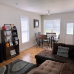 Living room with sectional sofa, and dining table