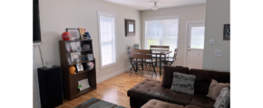 Living room with sectional sofa, and dining table