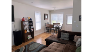 Living room with sectional sofa, and dining table