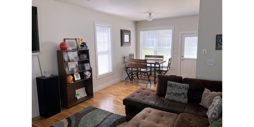 Living room with sectional sofa, and dining table