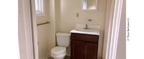 Bathroom with toilet, vanity, and mirror