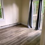Bedroom with laminate flooring, and slider door to patio