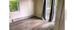 Bedroom with laminate flooring, and slider door to patio