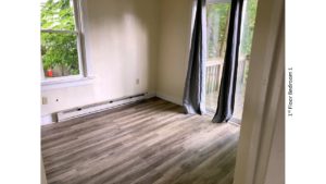 Bedroom with laminate flooring, and slider door to patio