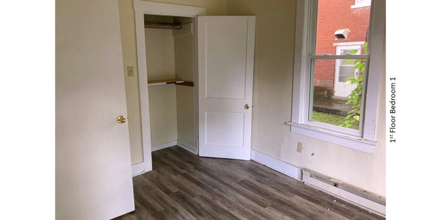 Bedroom with closet and large window