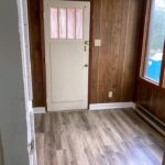 Entryway with large windows and wood paneling