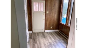 Entryway with large windows and wood paneling