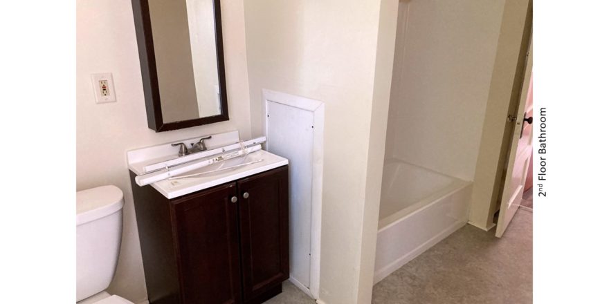 Bathroom with toilet, medicine cabinet, vanity, and tub/shower combo