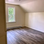 Bedroom with ceiling light and large window