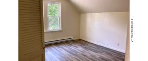 Bedroom with ceiling light and large window