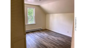 Bedroom with ceiling light and large window