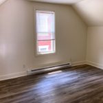 Living Room with sloped ceilings and window
