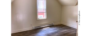 Living Room with sloped ceilings and window