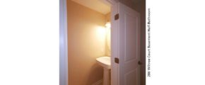 Half bathroom with pedestal sink and mirror