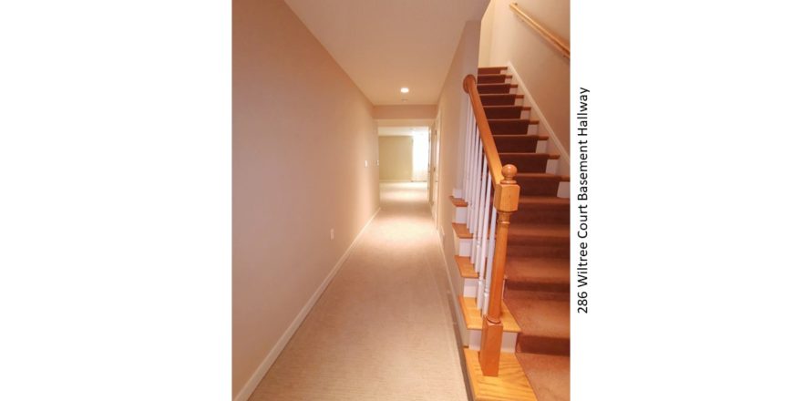 Carpeted hallway and staircase