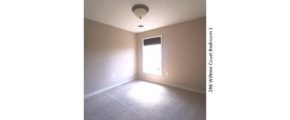 Carpeted bedroom with window and light fixture