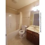 Full bathroom with vanity, mirror, toilet, and tub/shower combo