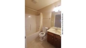 Full bathroom with vanity, mirror, toilet, and tub/shower combo