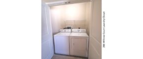 Laundry closet with side-by-side washer and dryer and shelving