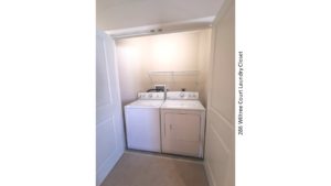 Laundry closet with side-by-side washer and dryer and shelving