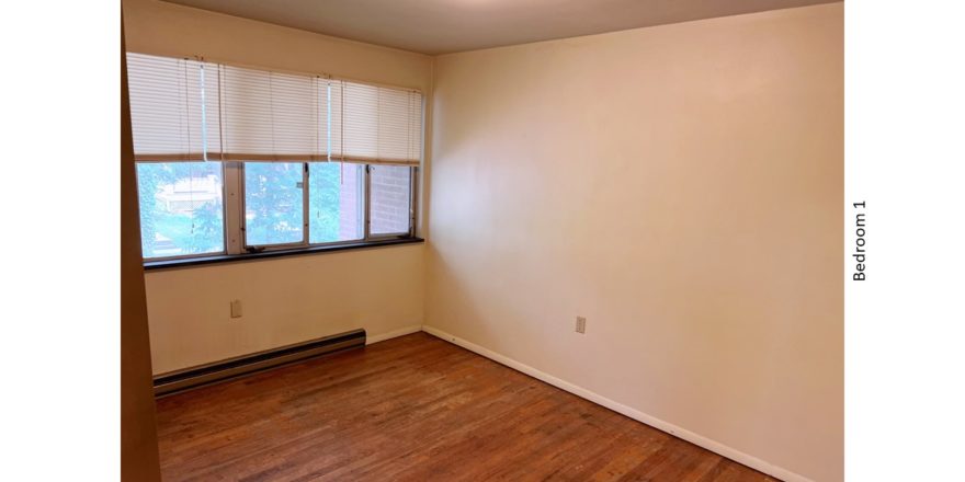 Unfurnished bedroom with hardwood floor
